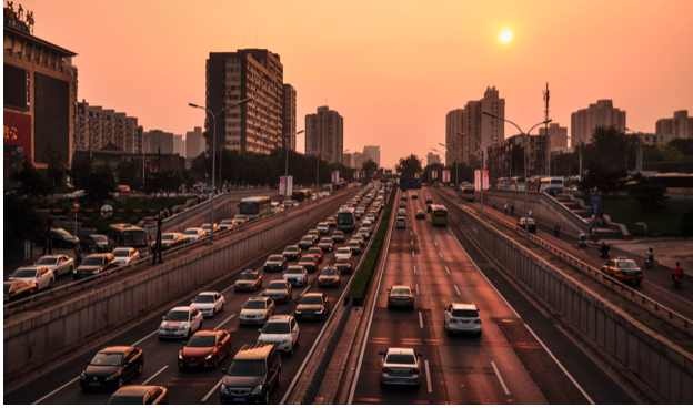 A view of a city street with bumper to bumper traffic 