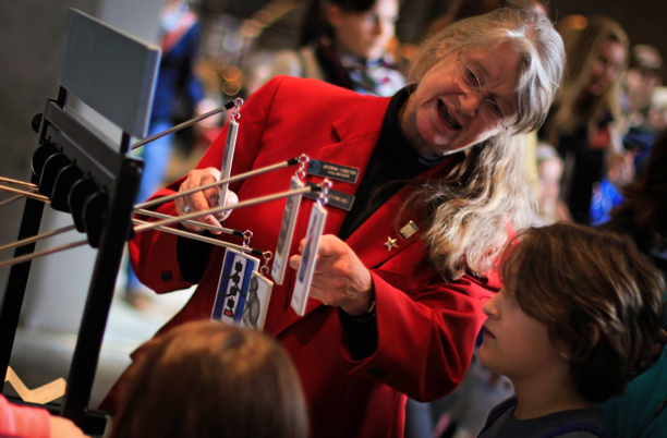 Museum docent explains an exhibit to children