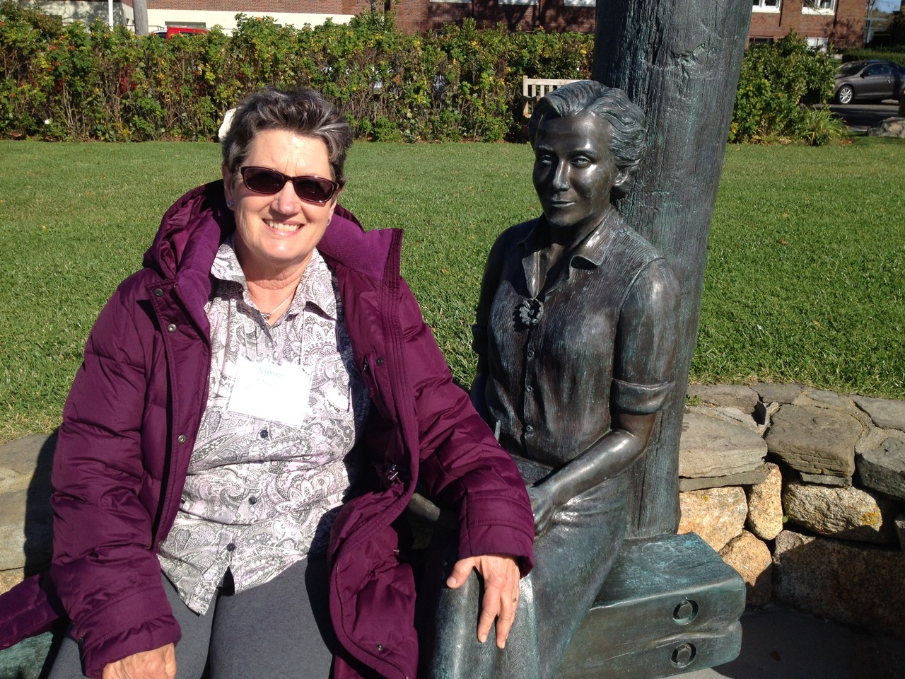 Simone sits beside a statue of Rachel Carson in Woods Hole, Massachusetts.