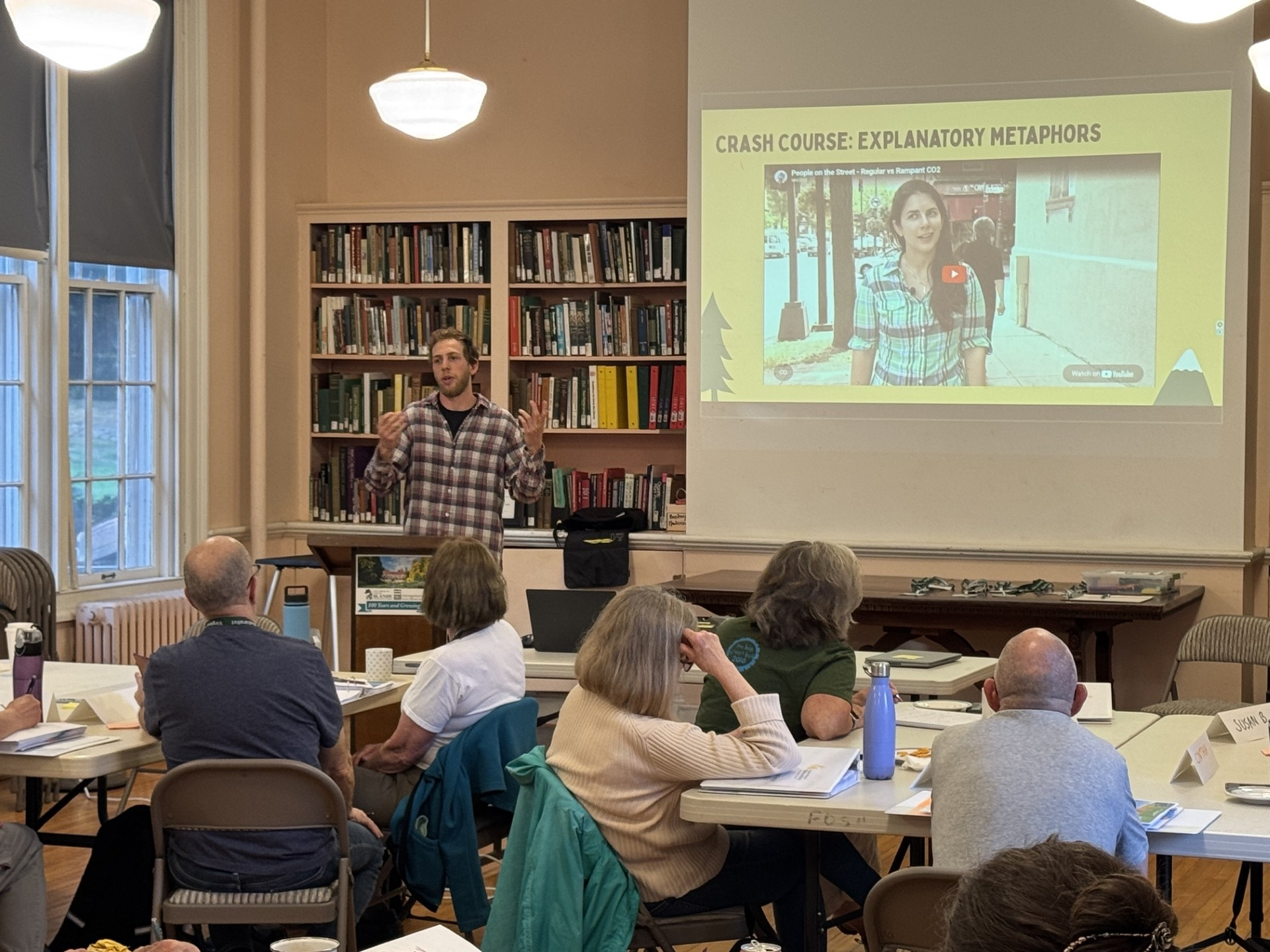 A presentation on NNOCCI and climate communication in a room with about twenty people.